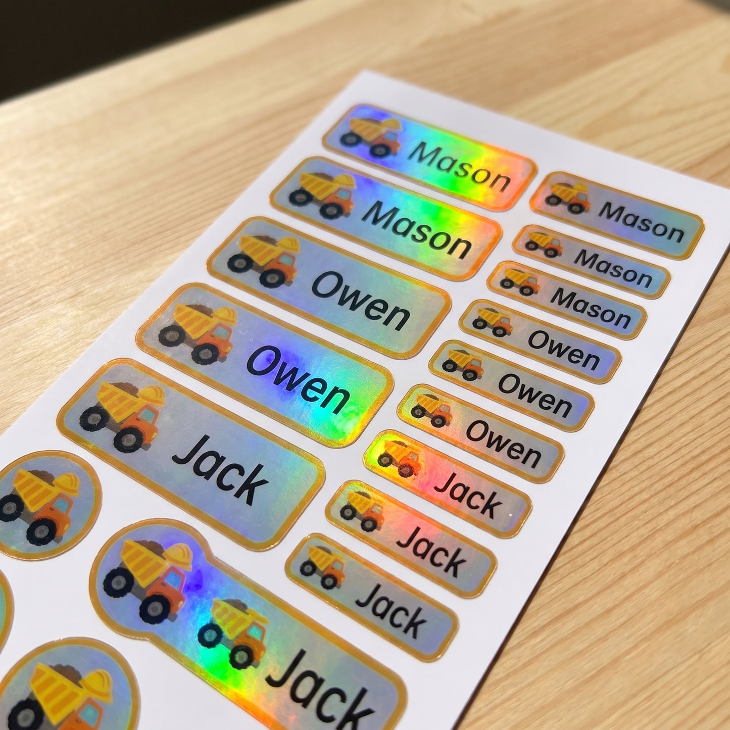 Holographic construction name label sticker sheet close-up with rainbow shimmer