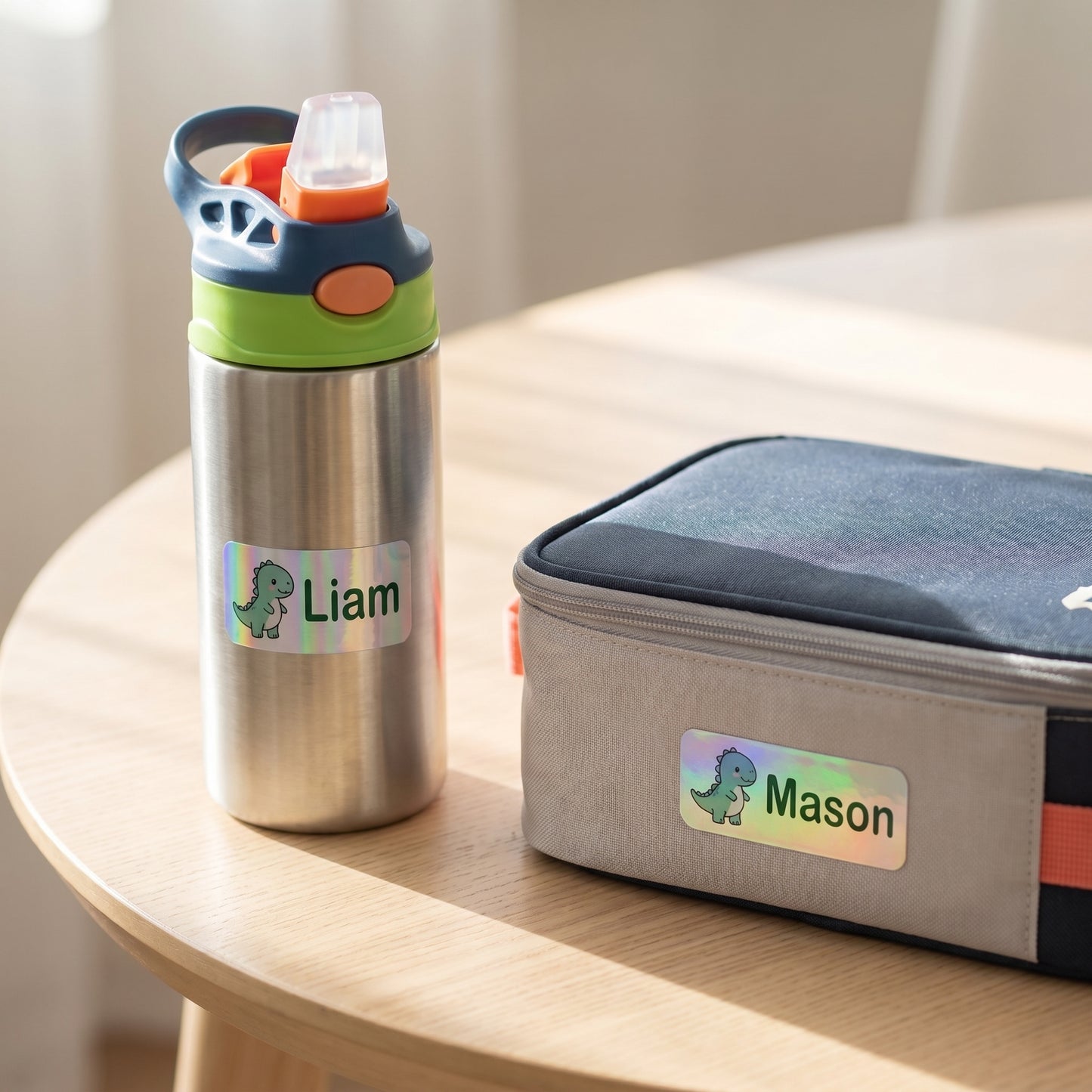 Personalized dinosaur name labels on a kids water bottle and lunchbox