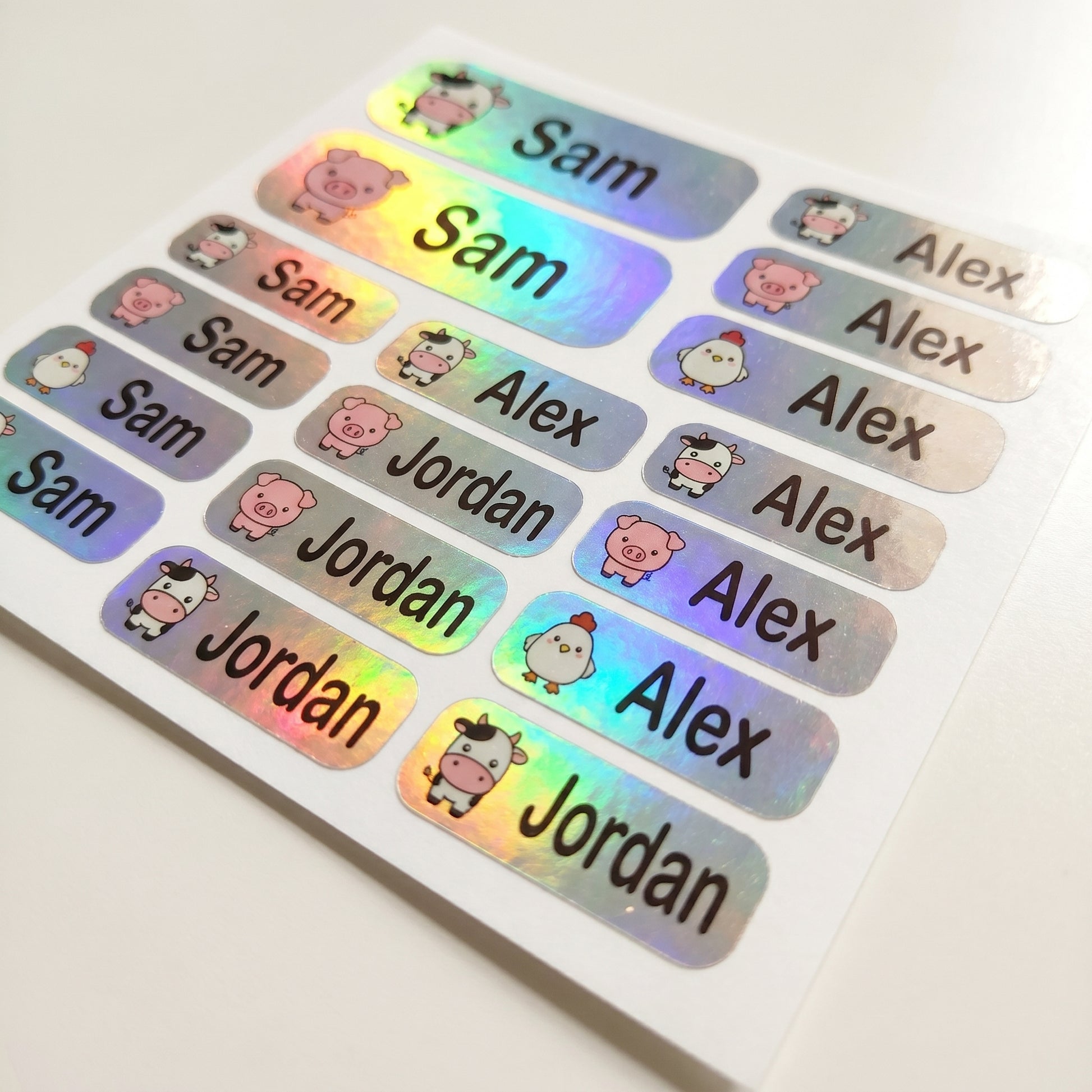 Holographic farm animals name label sticker sheet close-up with rainbow shimmer