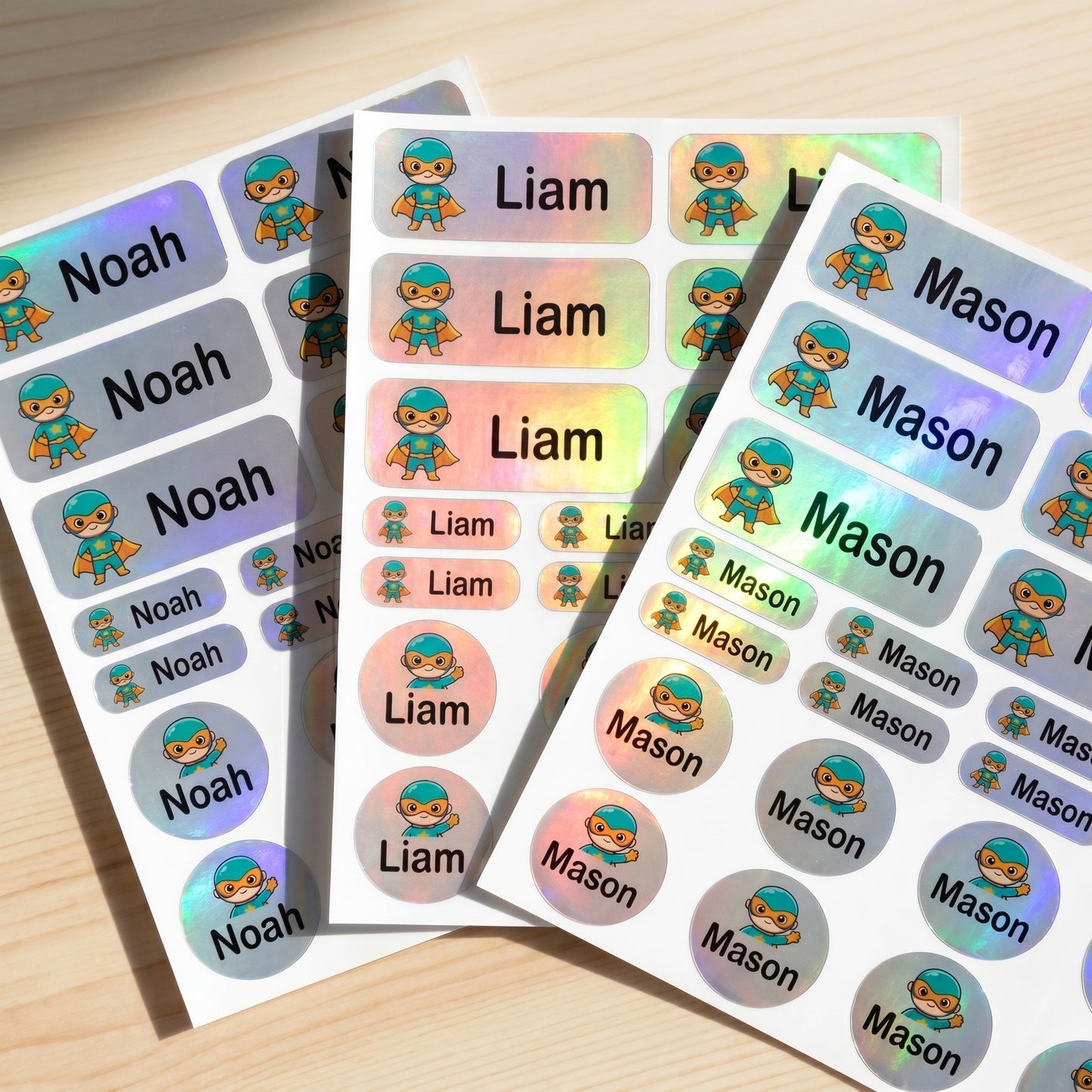Holographic caped hero name label sticker sheet close-up with rainbow shimmer