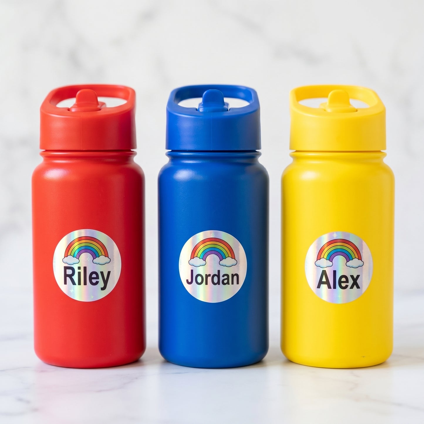 Personalized rainbow name labels on three kids water bottles