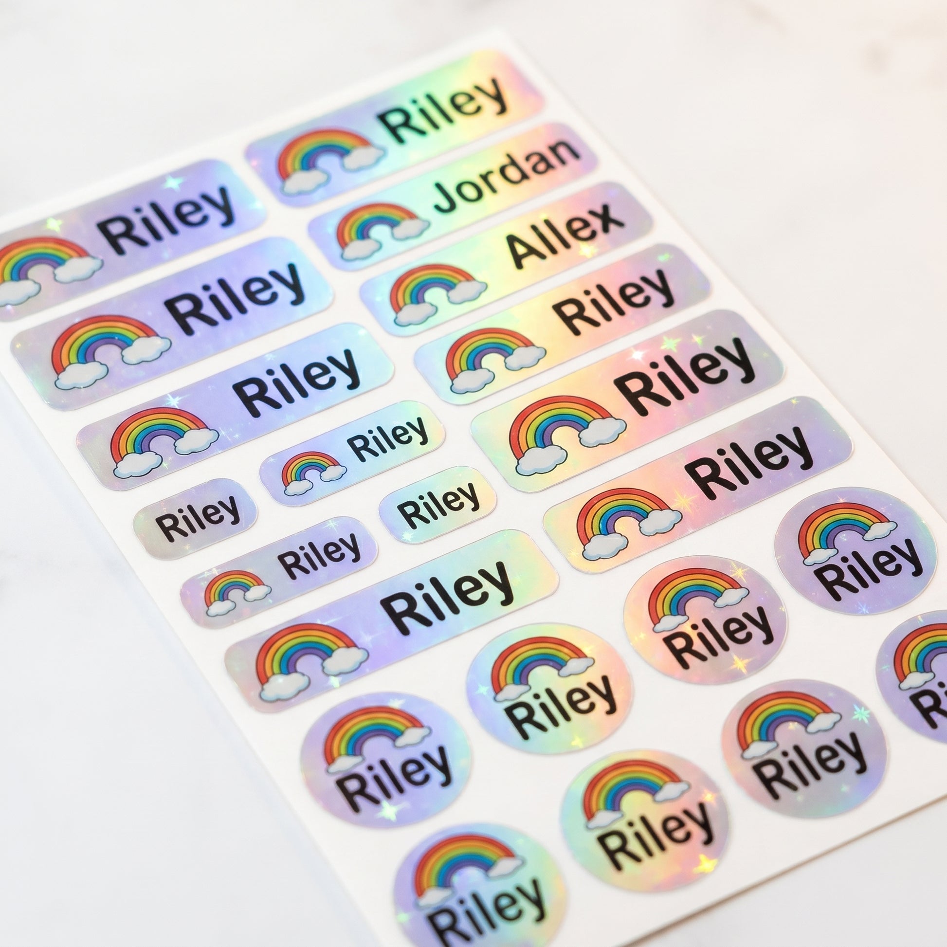 Holographic rainbow name label sticker sheet close-up with rainbow shimmer