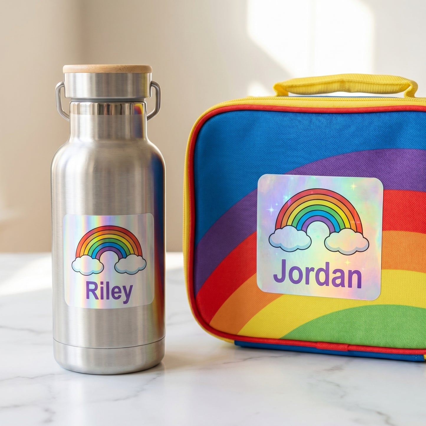 Personalized rainbow name labels on a kids water bottle and lunchbox