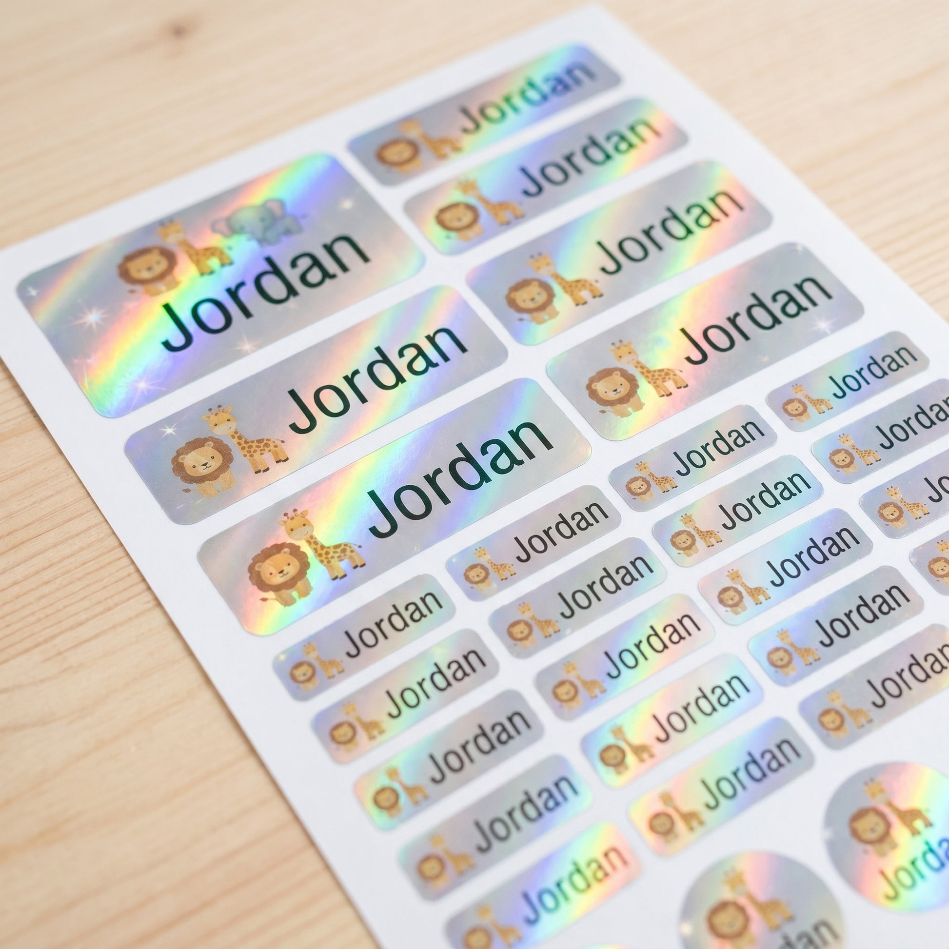 Holographic safari animals name label sticker sheet close-up with rainbow shimmer