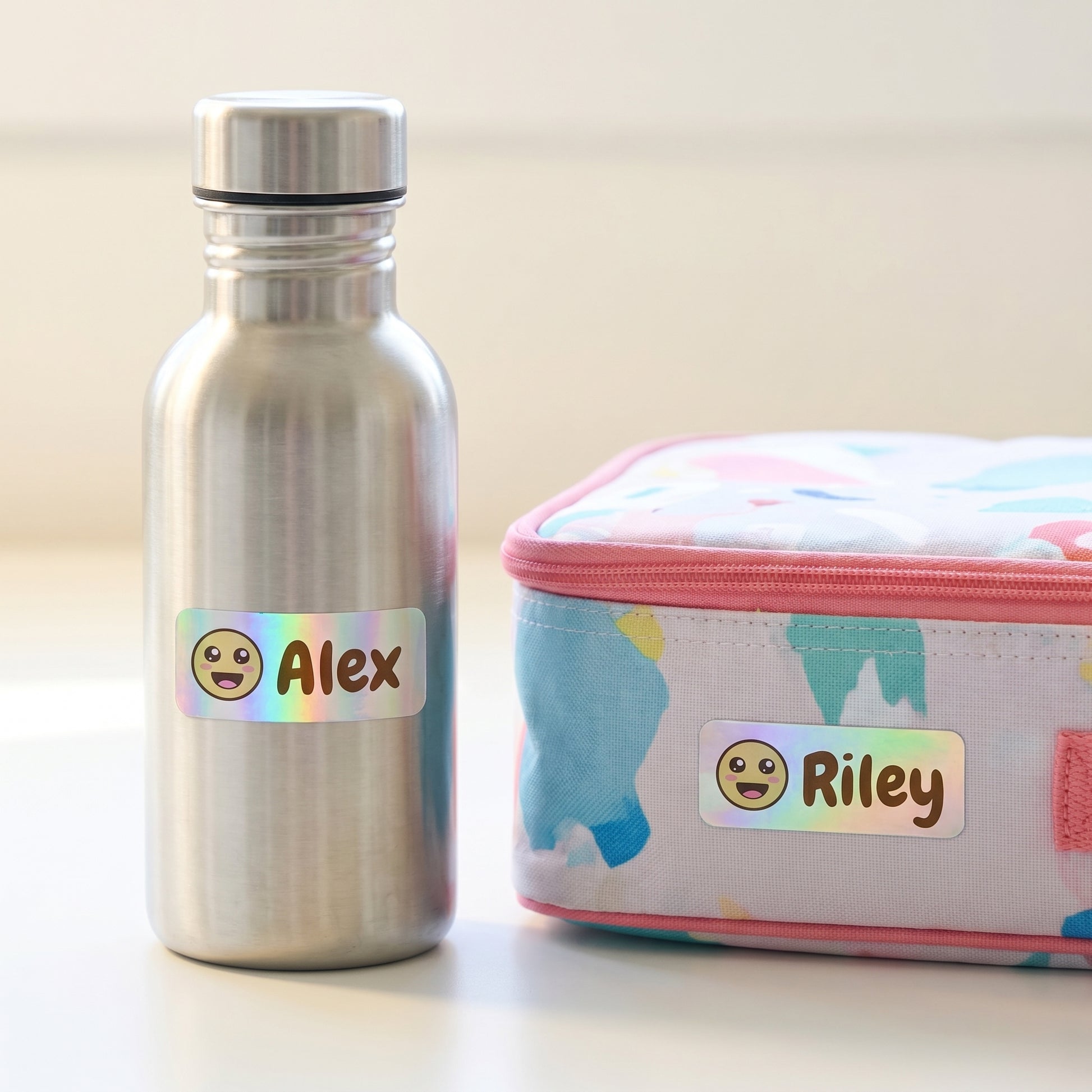 Personalized smiley name labels on a kids water bottle and lunchbox