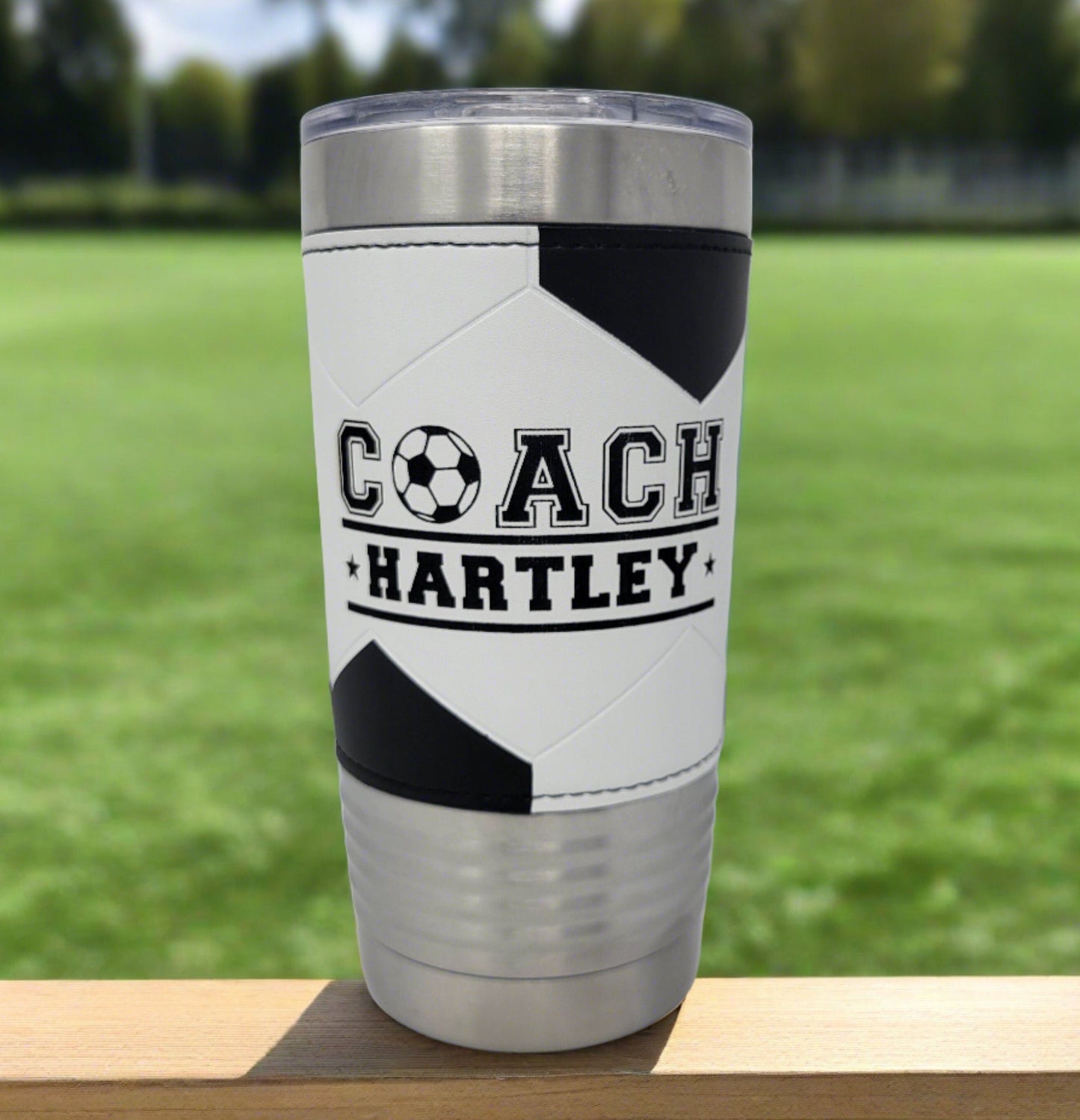 Close-up of laser engraving on soccer coach tumbler