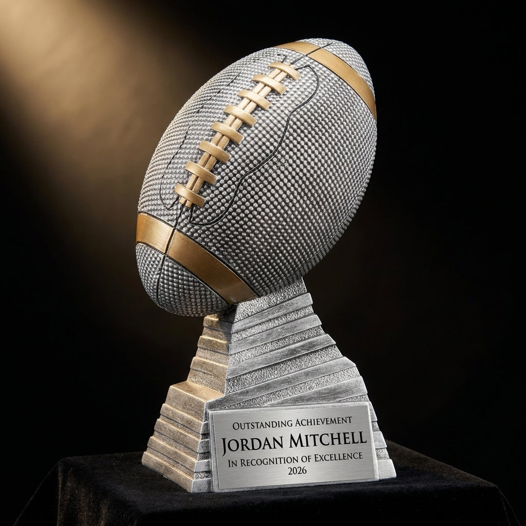 Personalized Antique Silver Football Stand Trophy resin award on black velvet under awards-ceremony spotlight, engraved champion and lifetime achievement award