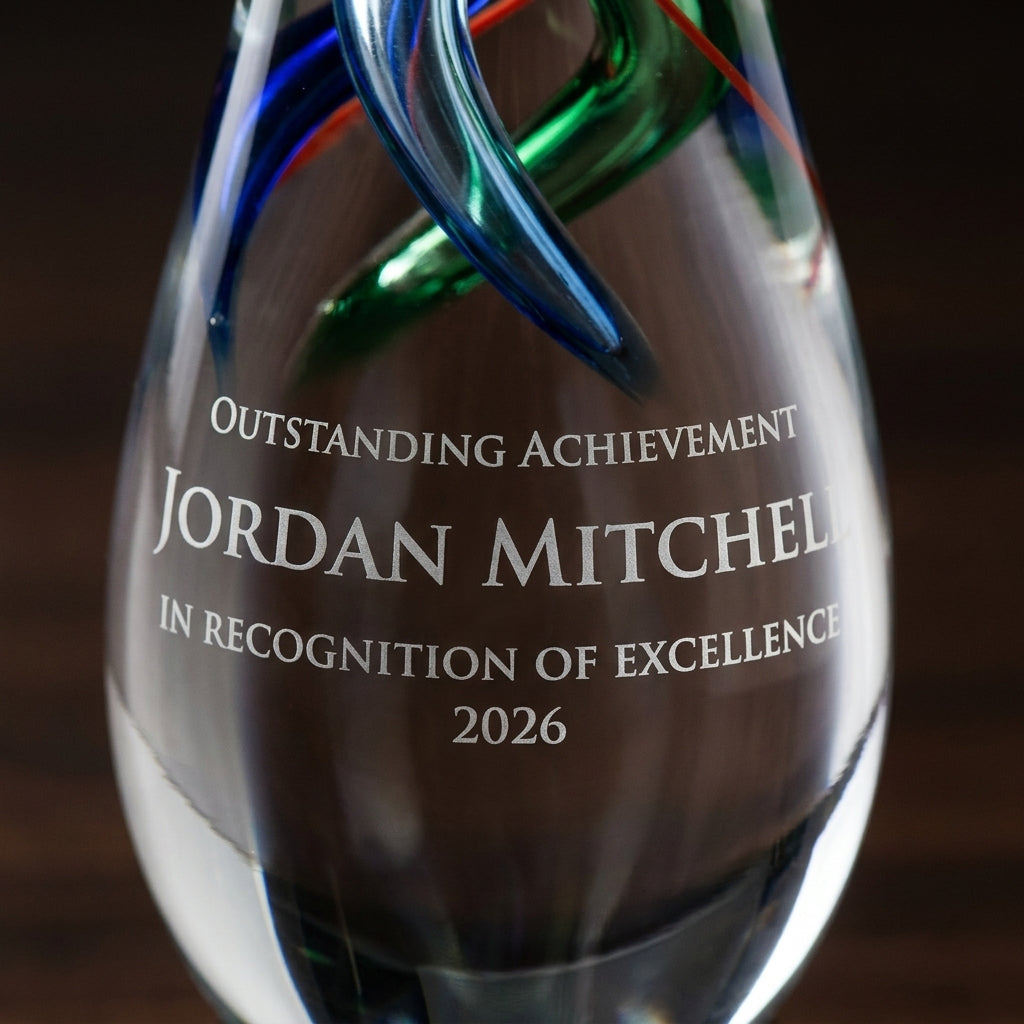 Close-up of the custom laser engraving on a personalized Art Glass art glass award, showing crisp permanent personalization