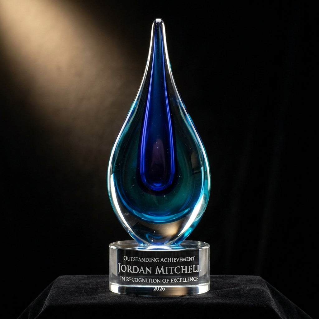 Personalized Blue art glass award on black velvet under awards-ceremony spotlight, engraved champion and lifetime achievement award