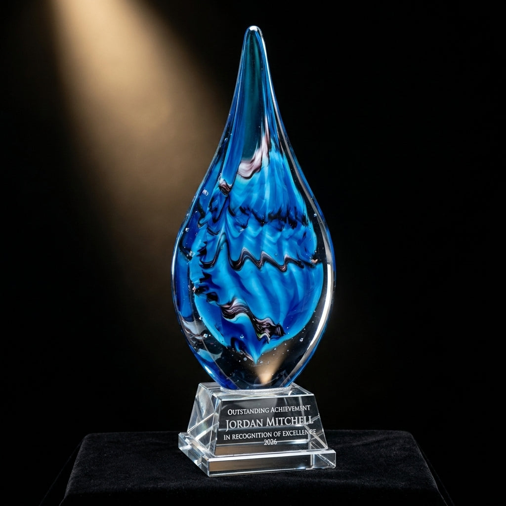 Personalized Flame Blue art glass award on black velvet under awards-ceremony spotlight, engraved champion and lifetime achievement award