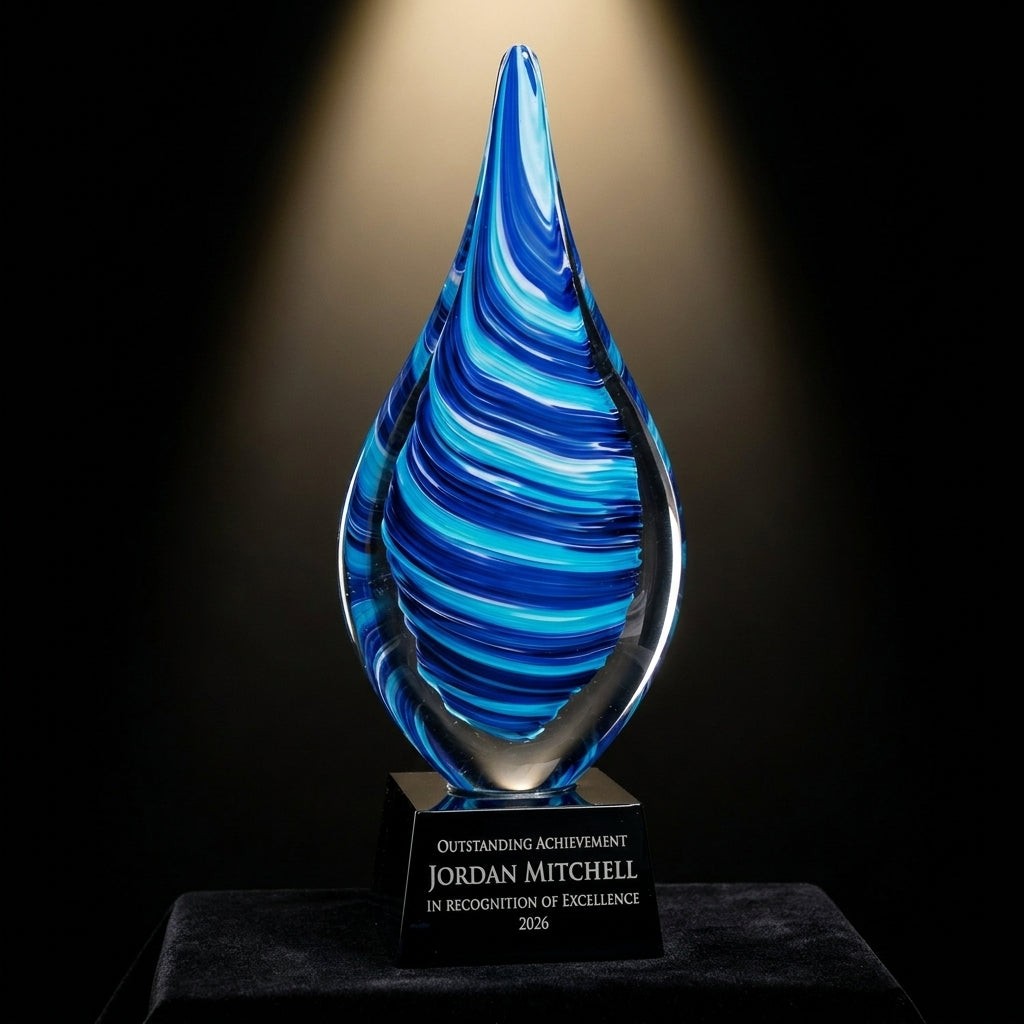Personalized Flame Blue art glass award on black velvet under awards-ceremony spotlight, engraved champion and lifetime achievement award