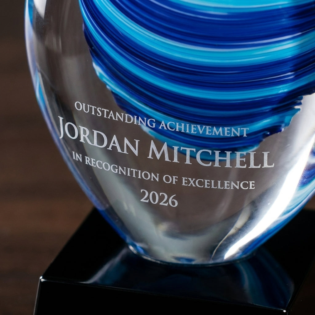 Close-up of the custom laser engraving on a personalized Flame Blue art glass award, showing crisp permanent personalization
