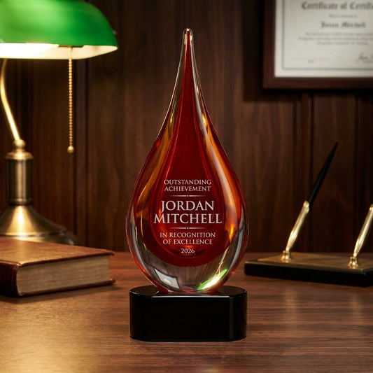 Personalized Red art glass award on a warm executive desk with a green banker's lamp, engraved corporate recognition and retirement gift