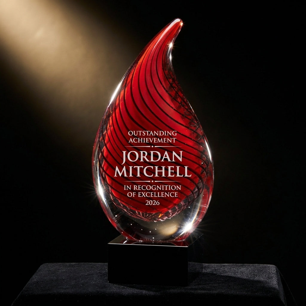 Personalized Red art glass award on black velvet under awards-ceremony spotlight, engraved champion and lifetime achievement award