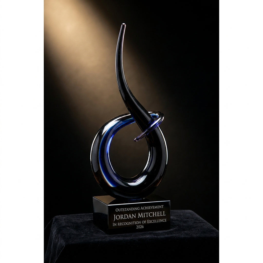 Personalized Black Blue Flame Knot art glass award on black velvet under awards-ceremony spotlight, engraved champion and lifetime achievement award