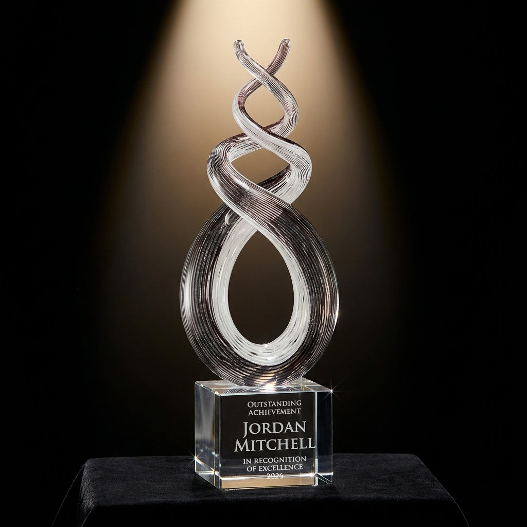 Personalized Plum Twist Spire art glass award on black velvet under awards-ceremony spotlight, engraved champion and lifetime achievement award
