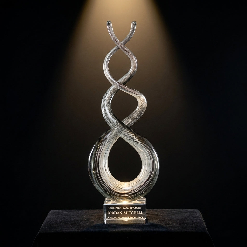 Personalized Smoke Crystal Twist art glass award on black velvet under awards-ceremony spotlight, engraved champion and lifetime achievement award