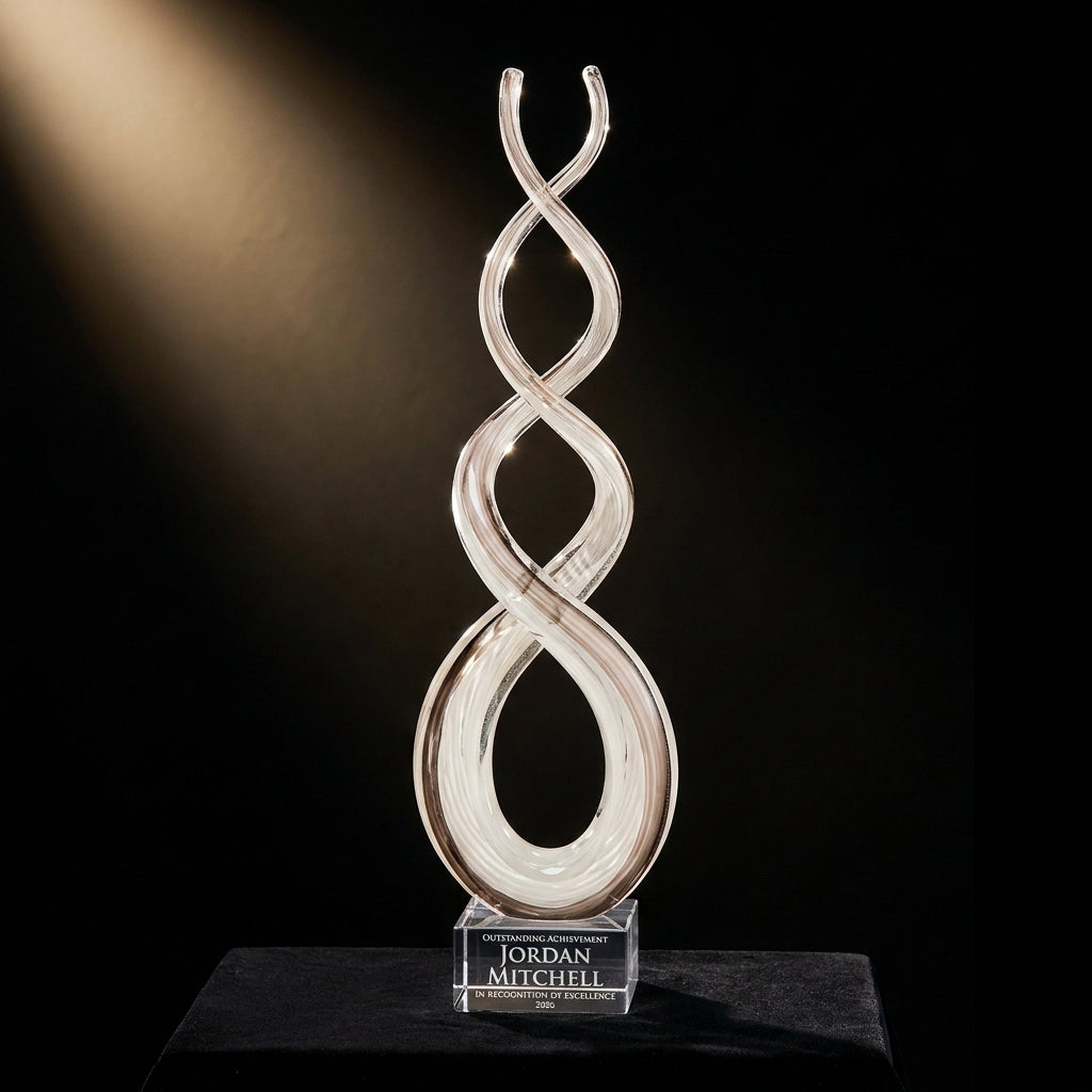 Personalized Amber Caramel Infinity art glass award on black velvet under awards-ceremony spotlight, engraved champion and lifetime achievement award