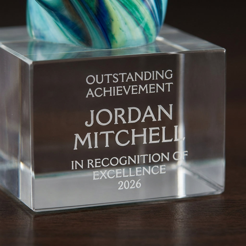Close-up of the custom laser engraving on a personalized Sculpture art glass award, showing crisp permanent personalization