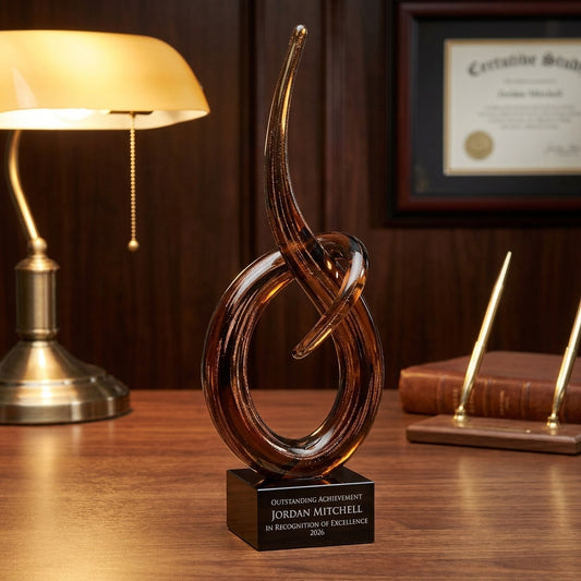 Personalized Small art glass award on a warm executive desk with a green banker's lamp, engraved corporate recognition and retirement gift