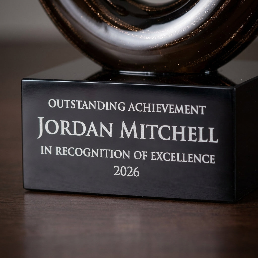 Close-up of the custom laser engraving on a personalized Small art glass award, showing crisp permanent personalization