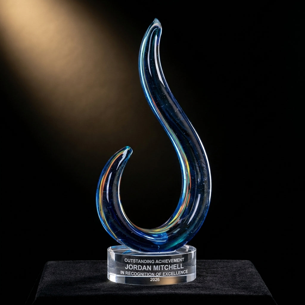 Personalized Swirl art glass award on black velvet under awards-ceremony spotlight, engraved champion and lifetime achievement award