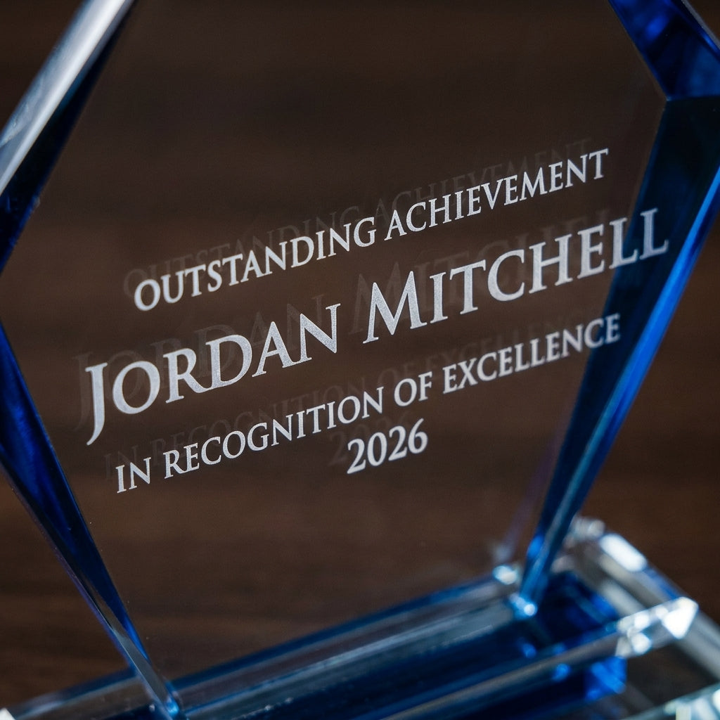 Close-up of the custom laser engraving on a personalized Black Arrow Clear Base crystal award, showing crisp permanent personalization