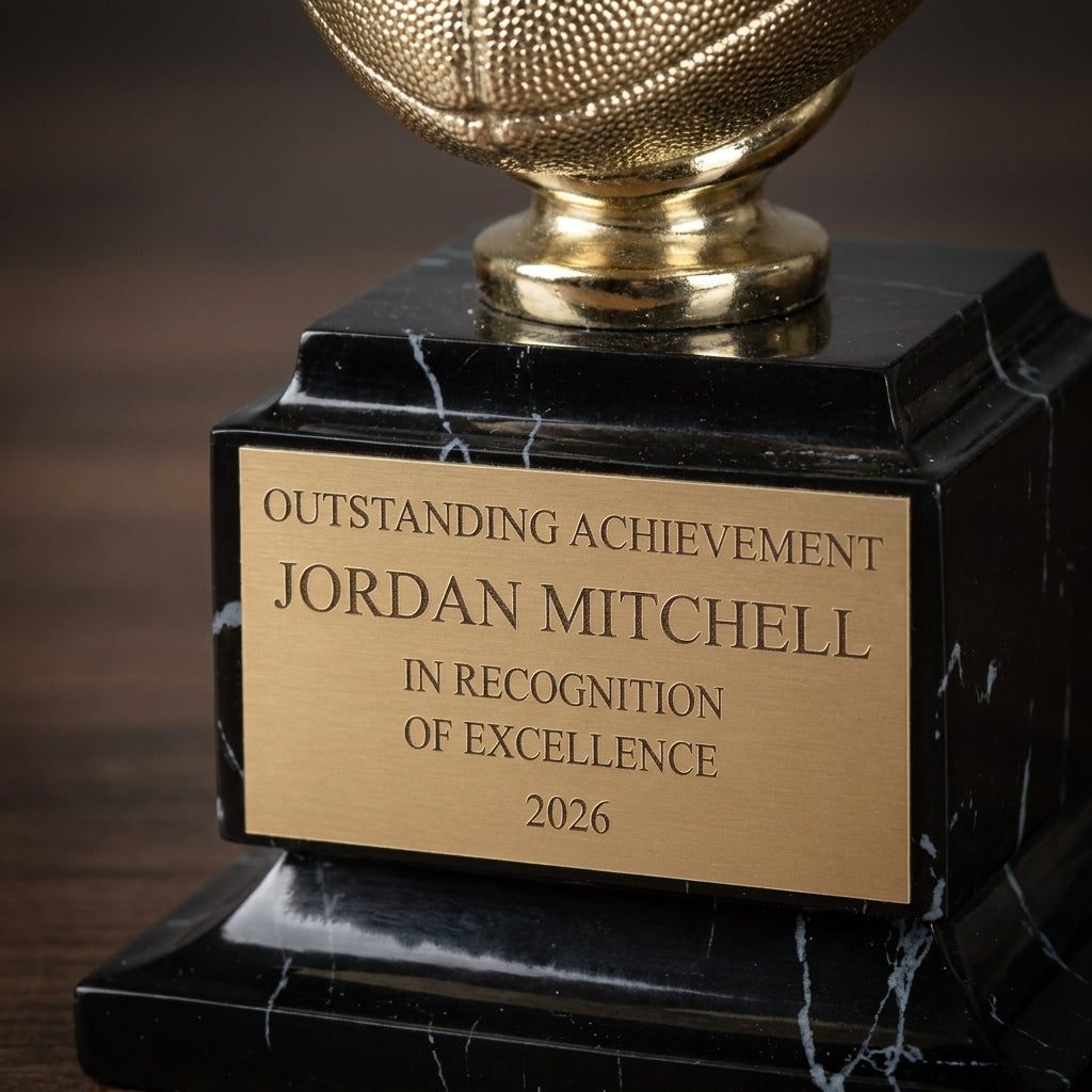 Close-up of the custom laser engraving on a personalized Bright Gold Football Resin Trophy resin award, showing crisp permanent personalization