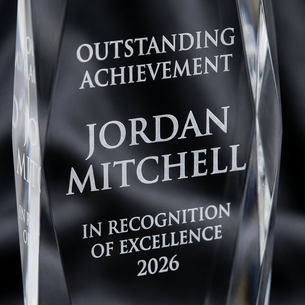 Close-up of the custom laser engraving on a personalized Crystal Tower 3D Soccer Award crystal award, showing crisp permanent personalization