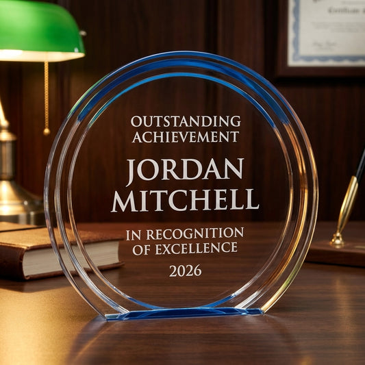 Personalized Double Halo Circle Bl acrylic award on a warm executive desk with a green banker's lamp, engraved corporate recognition and retirement gift