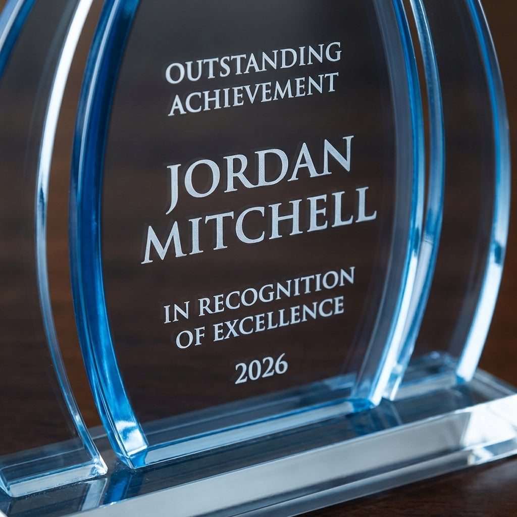 Close-up of the custom laser engraving on a personalized Dyn Enterprise acrylic award, showing crisp permanent personalization