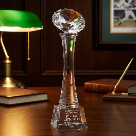 Personalized Elegant Crystal Football On Tall Crystal Base Award crystal award on a warm executive desk with a green banker's lamp, engraved corporate recognition and retirement gift