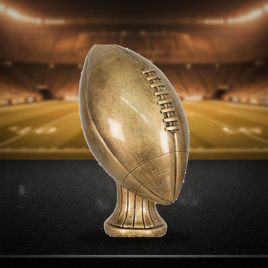 Personalized Football Antique Metallic Resin Award resin award on a warm executive desk with a green banker's lamp, engraved corporate recognition and retirement gift
