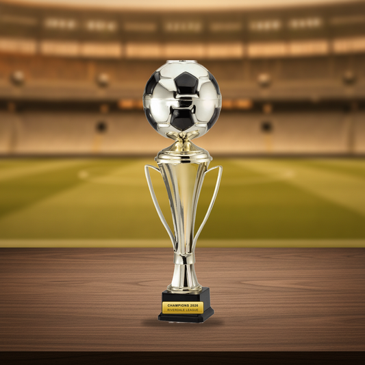 Personalized Gold Cup With Soccer Ball On Elegant Black Synthetic Base cup trophy on a warm executive desk with a green banker's lamp, engraved corporate recognition and retirement gift
