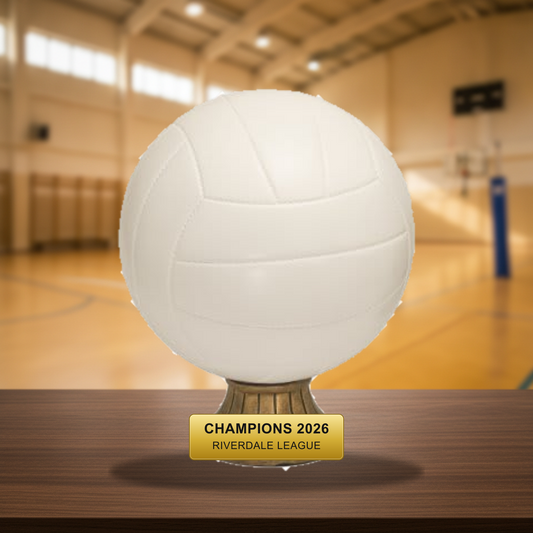 Personalized Volleyball Resin Trophy Award resin award on a warm executive desk with a green banker's lamp, engraved corporate recognition and retirement gift