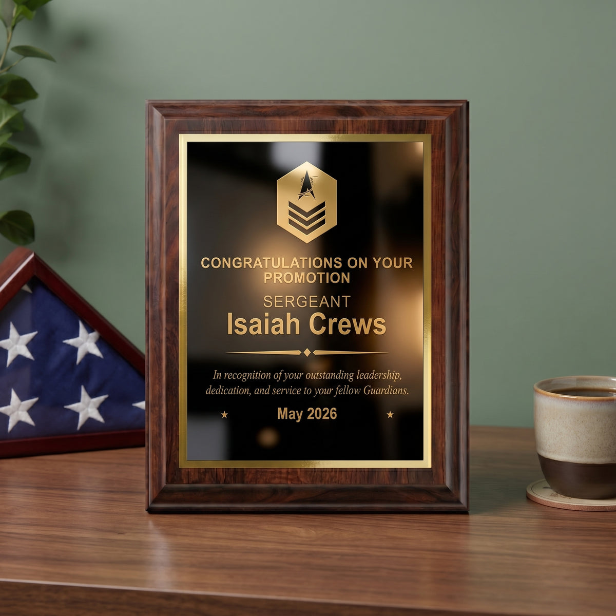 Personalized Space Force cherry plaque with a Sergeant insignia and name engraved in gold on a black brass plate, styled as a promotion gift on a desk