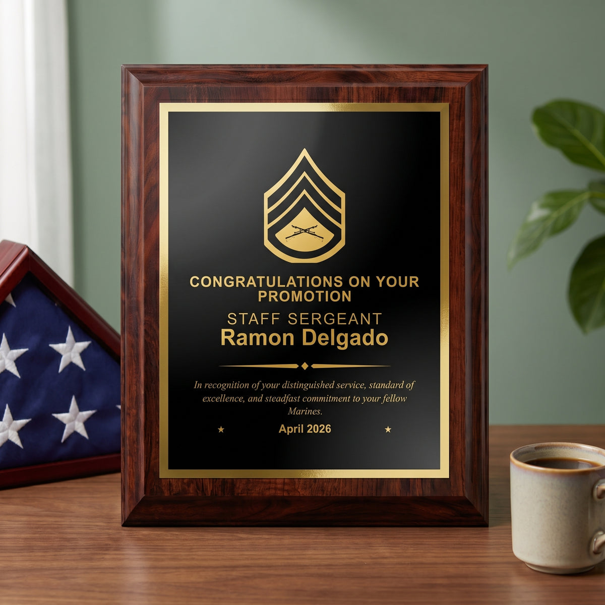 Personalized Marine Corps cherry plaque with a Staff Sergeant insignia and name engraved in gold on a black brass plate, styled as a promotion gift on a desk