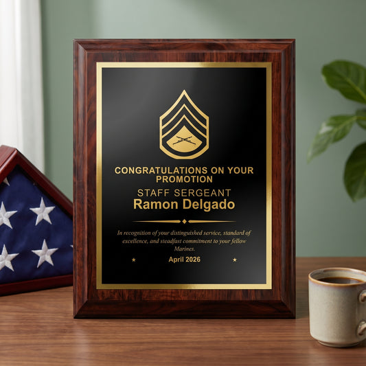 Personalized Marine Corps cherry plaque with a Staff Sergeant insignia and name engraved in gold on a black brass plate, styled as a promotion gift on a desk