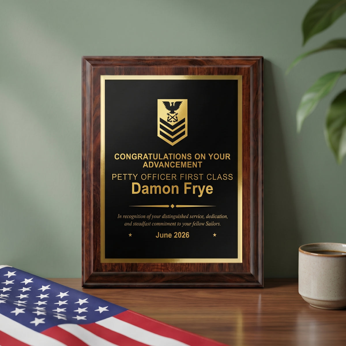 Personalized Navy cherry plaque with a Petty Officer First Class insignia and name engraved in gold on a black brass plate, styled as an advancement gift on a desk