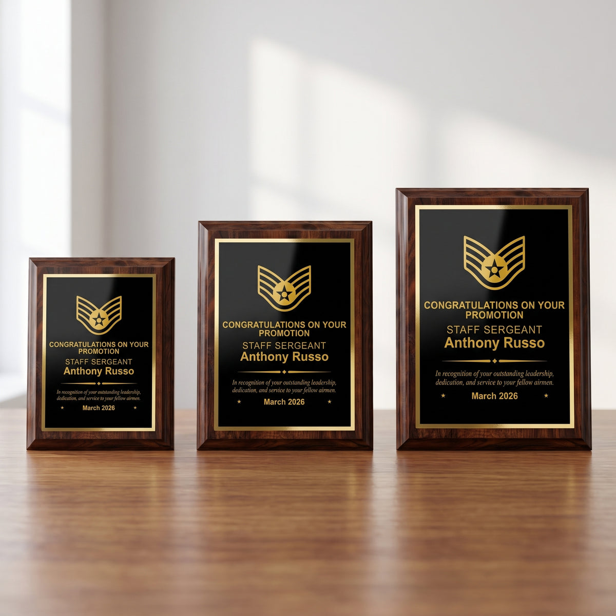 Small, medium, and large Air Force cherry plaques side by side showing the engraved Staff Sergeant insignia and name scaled to each plaque size