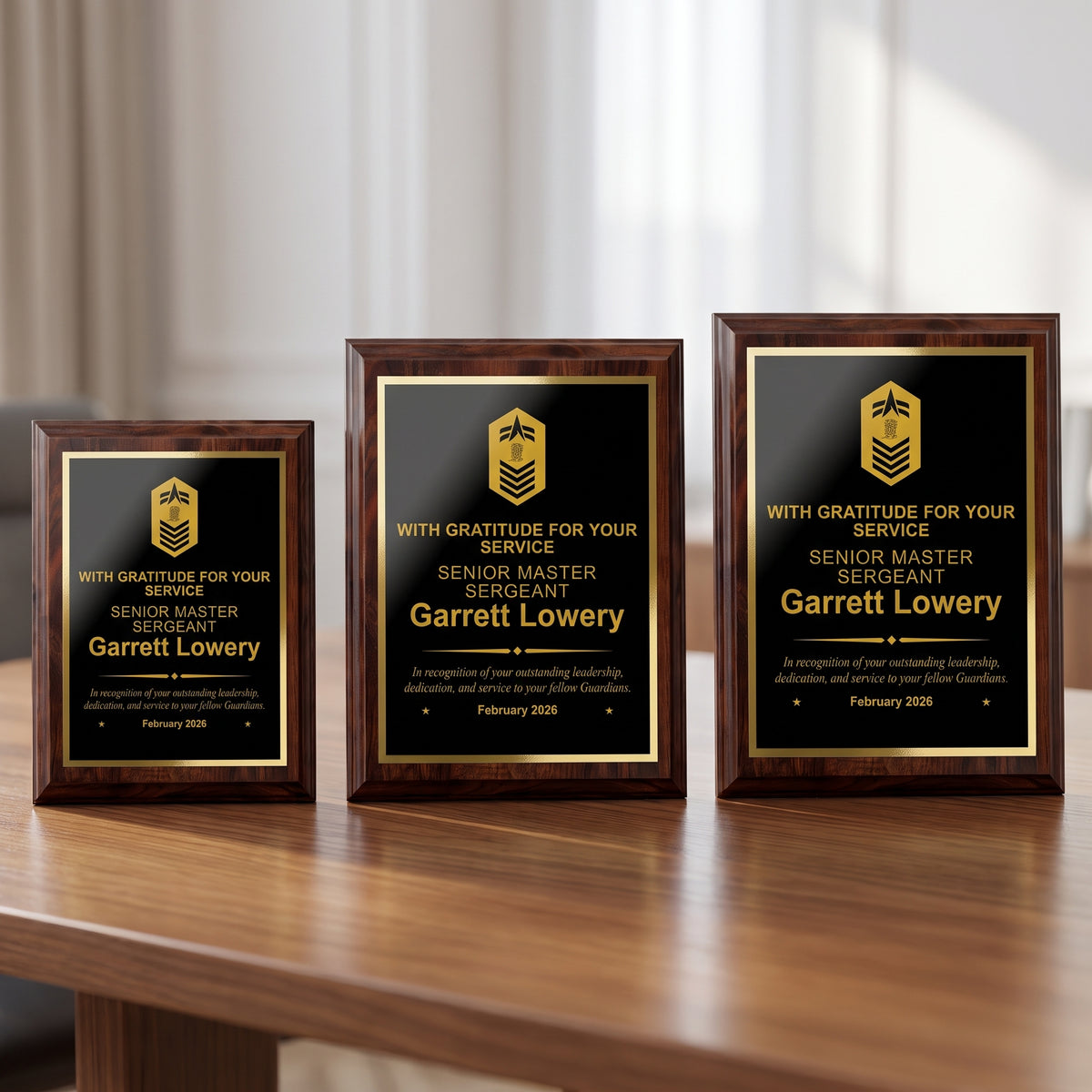 Small, medium, and large Space Force cherry plaques side by side showing the engraved Senior Master Sergeant insignia and name scaled to each plaque size