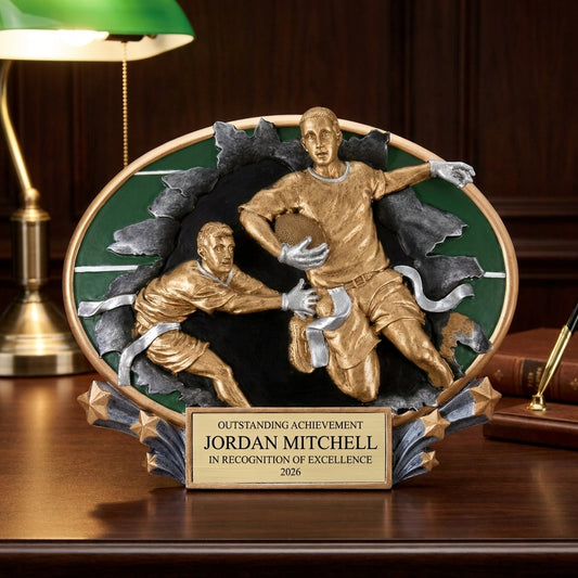 Personalized Motion Flag Football Resin Trophy resin award on a warm executive desk with a green banker's lamp, engraved corporate recognition and retirement gift
