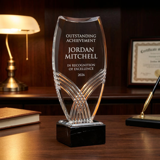 Personalized Nile Tower acrylic award on a warm executive desk with a green banker's lamp, engraved corporate recognition and retirement gift