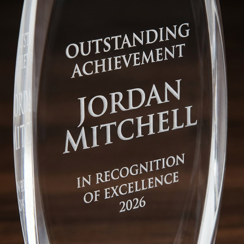 Close-up of the custom laser engraving on a personalized Nile Tower acrylic award, showing crisp permanent personalization