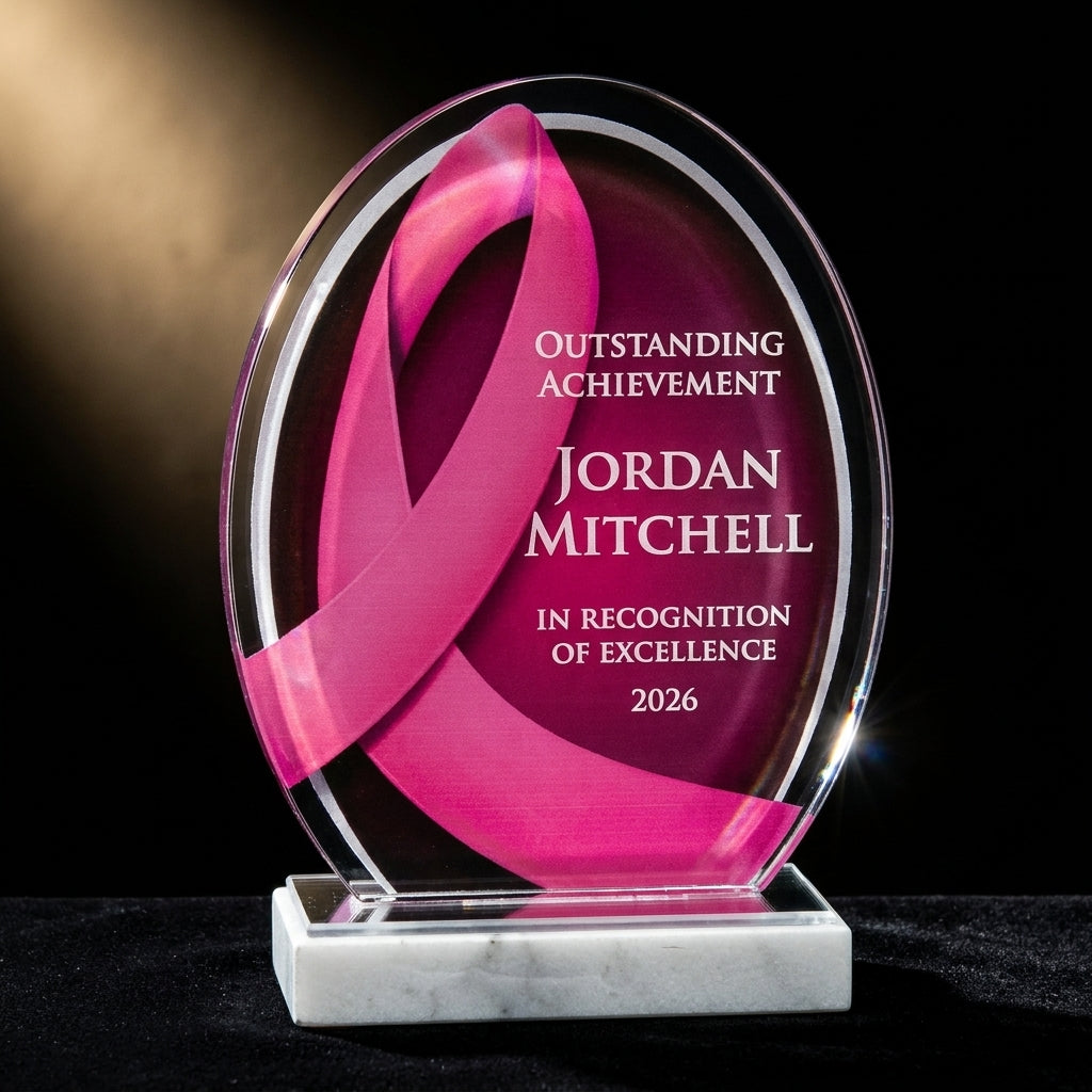 Personalized Pink Ribbon acrylic award on black velvet under awards-ceremony spotlight, engraved champion and lifetime achievement award