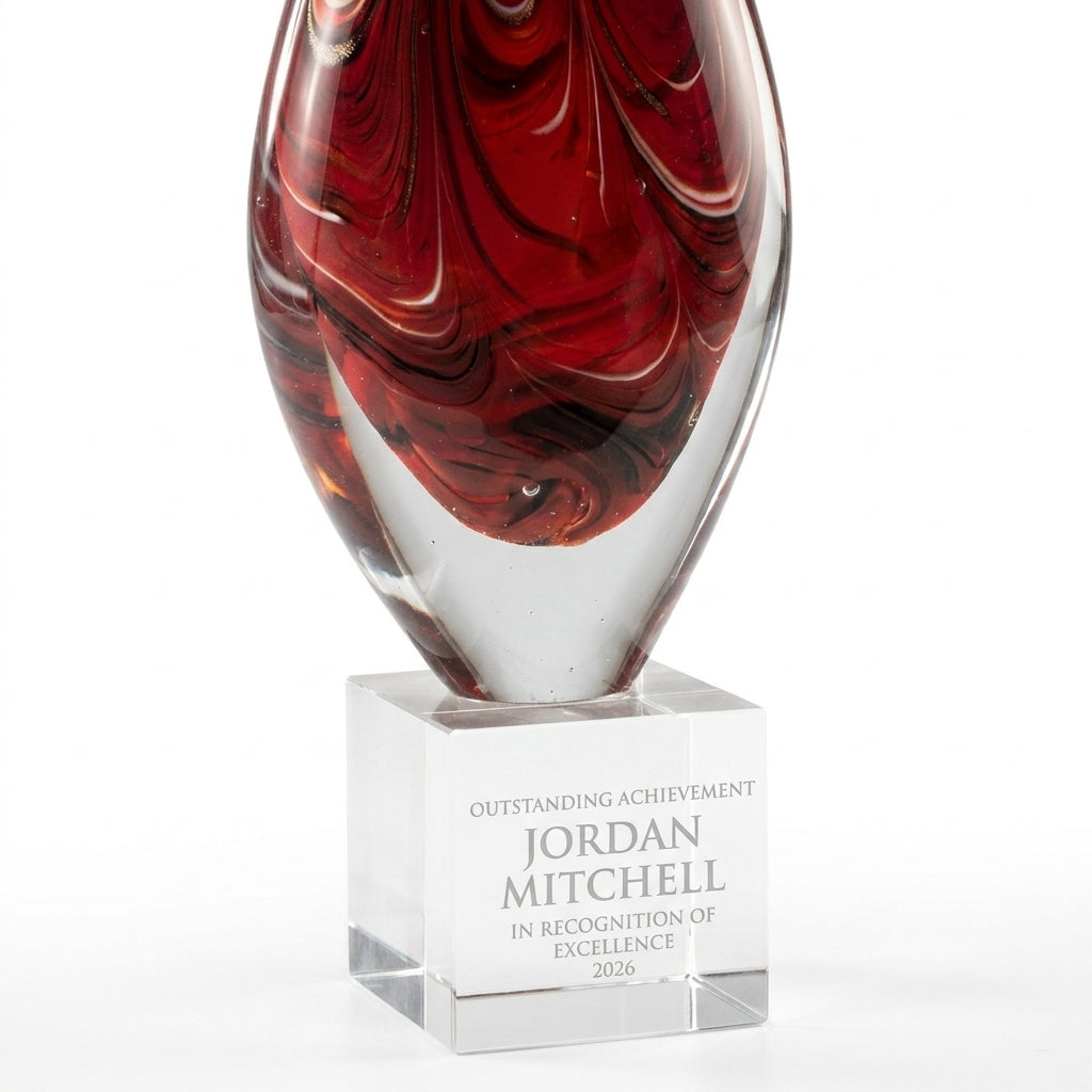 Personalized Red Swirl Teardrop art glass award, custom laser engraved recognition award on a clean white studio background