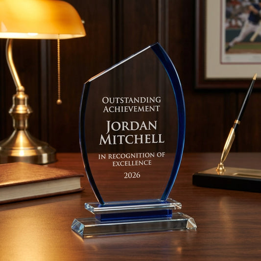 Personalized Semi Oval crystal award on a warm executive desk with a green banker's lamp, engraved corporate recognition and retirement gift