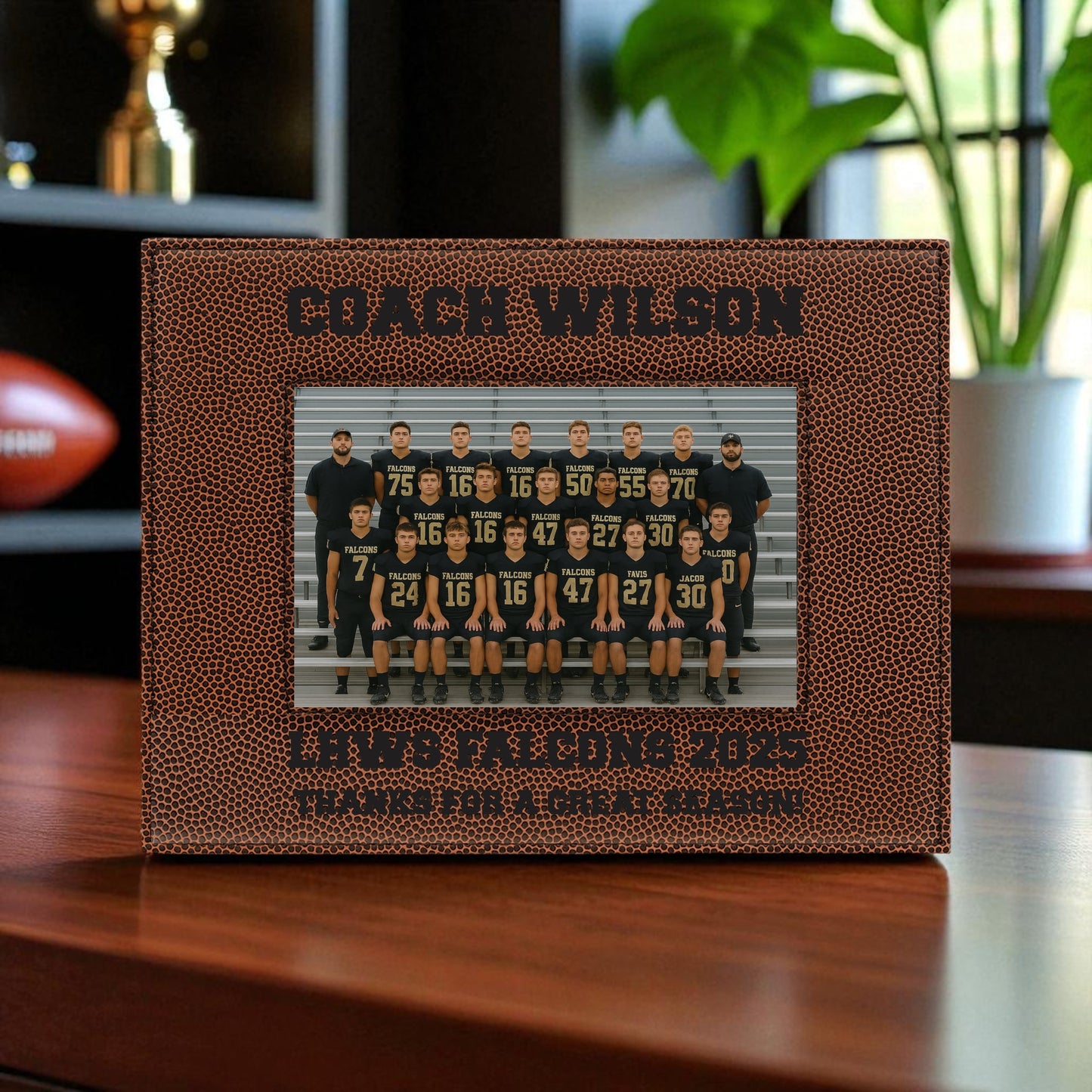 Personalized photo frame with football texture displaying a team photo, placed on a wooden surface.