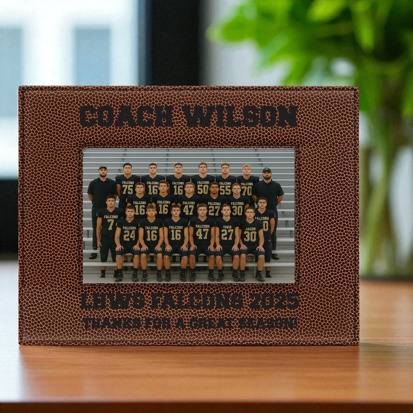 Football-themed photo frame with 'Coach Wilson' and team picture on a wooden surface.